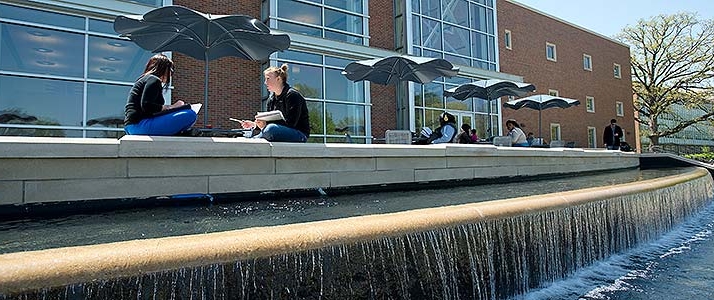 students on patio outside of Morris Library
