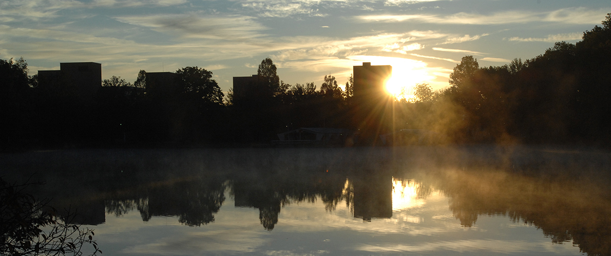 view of campus lake against sunset