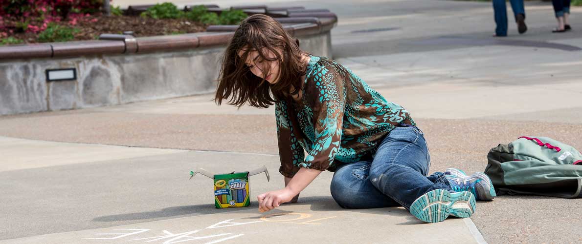 student drawing chalk