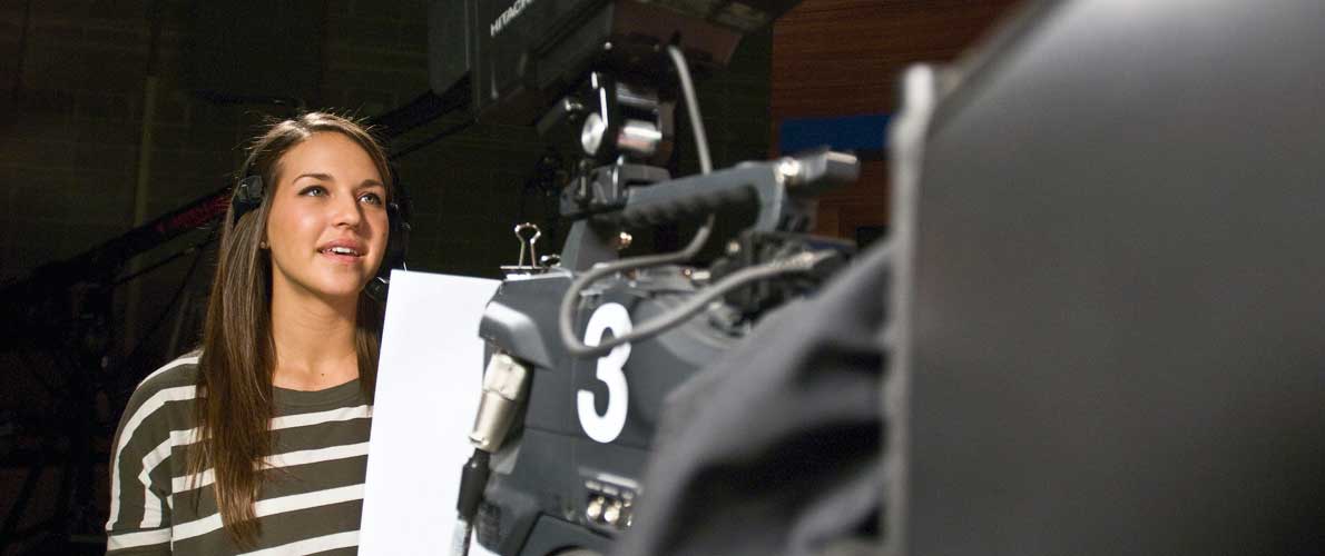 student behind camera