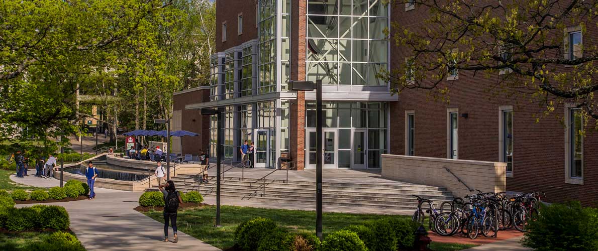 The main entrance of Morris Library with students walking past