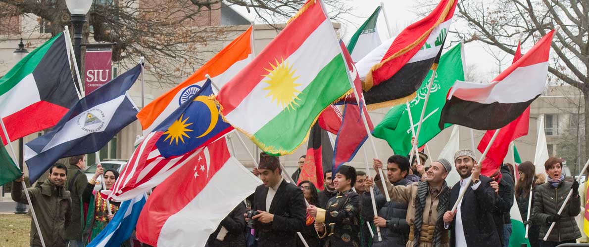 SIU students and staff holding flags representing their country on SIU campus