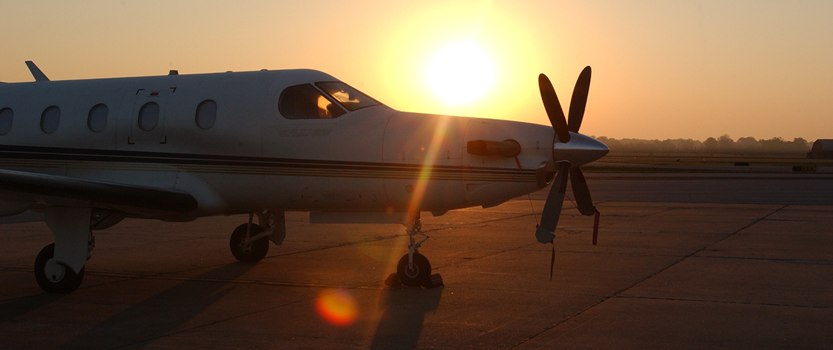 Plane on runway during sunset