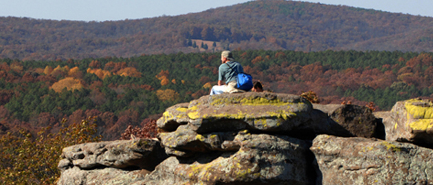 Student sitting on a rocky area 