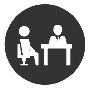 Two people sitting at an office desk