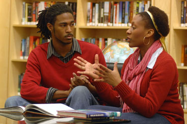 man and woman talking in library